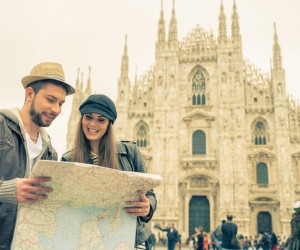Tourists looking at a city map in front of the Duomo in Milan